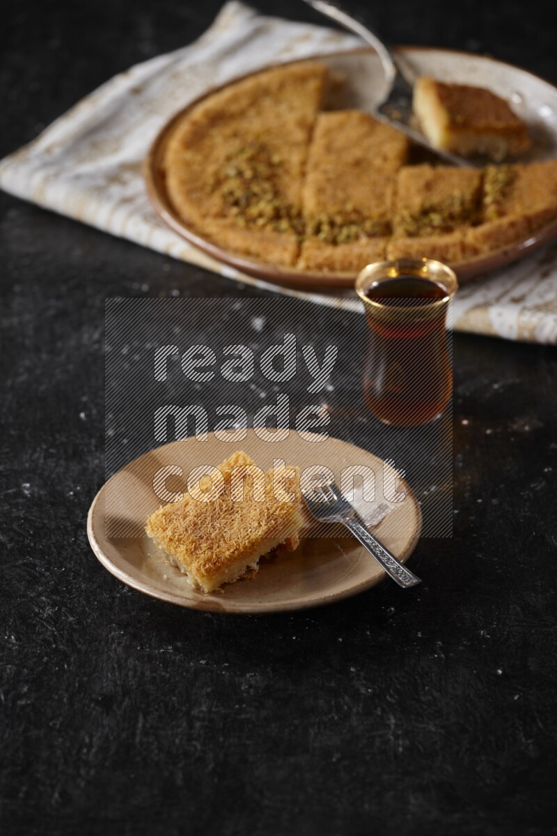 konafa with tea in a dark setup