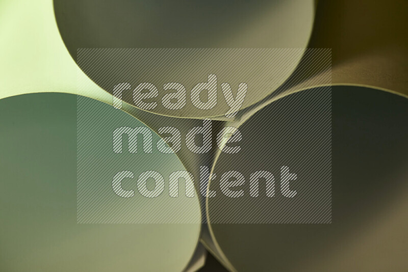 The image shows an abstract paper art with circular shapes in varying shades of green and warm tones