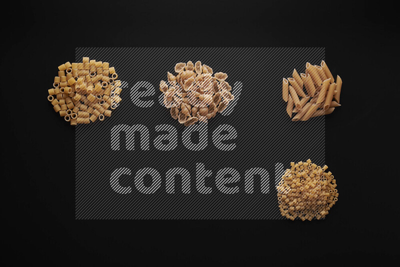 Different pasta types in bunches on black background