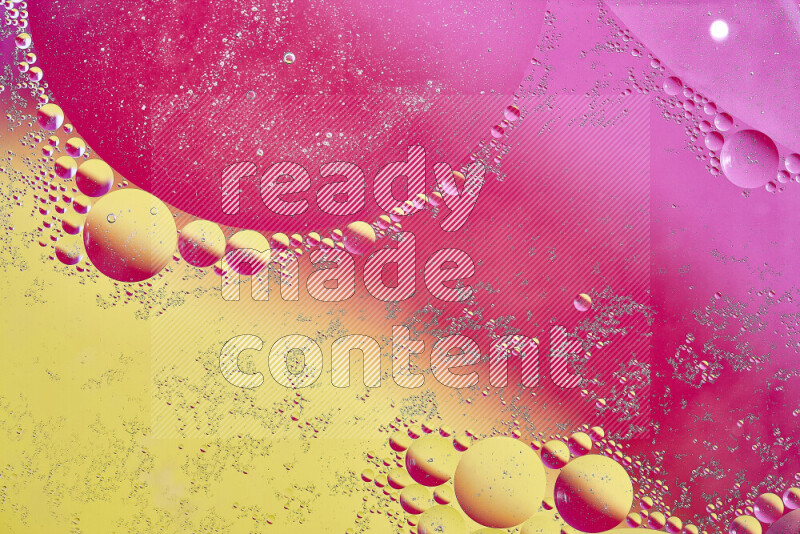 Close-ups of abstract oil bubbles on water surface in shades of yellow and pink