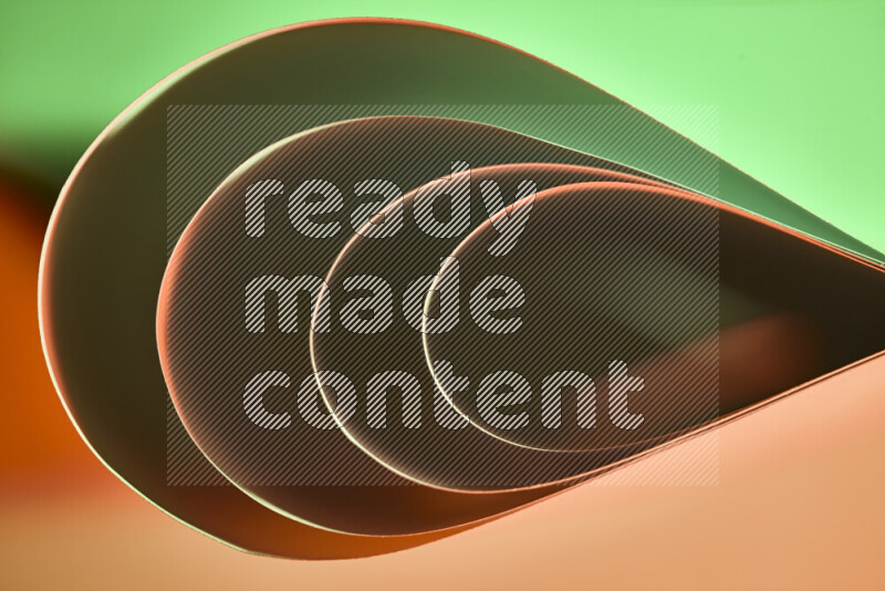 An abstract art of paper folded into smooth curves in green and orange gradients