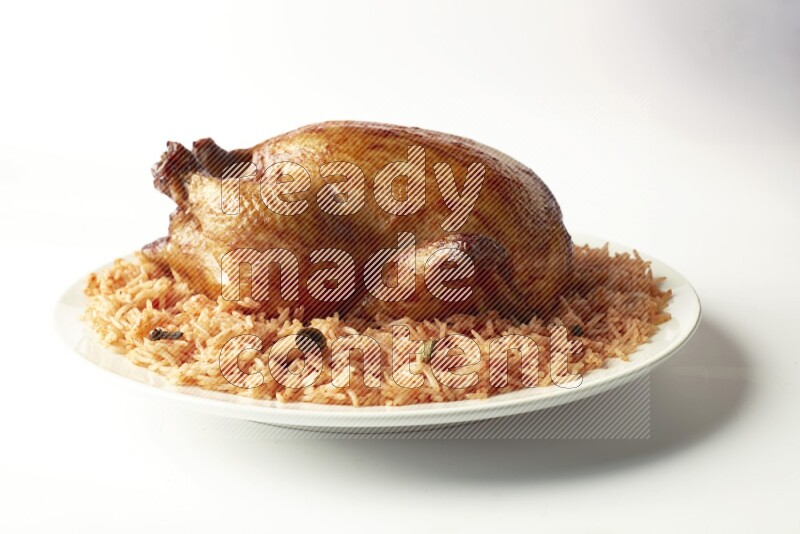 red basmati Rice with  whole roasted chicken on a white rounded plate  direct  on white background