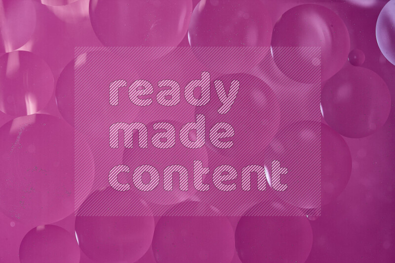Close-ups of abstract oil bubbles on water surface in shades of pink