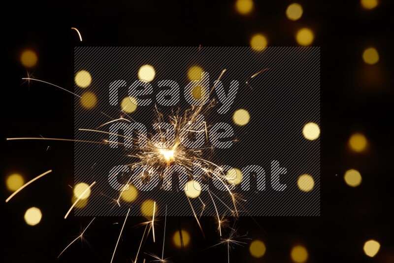 Sparkler candle with yellow light bokeh background