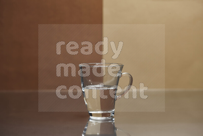 The image features a clear glassware filled with water, set against brown and light brown background