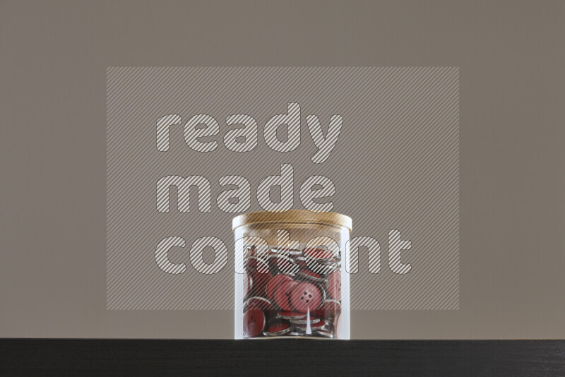 Buttons in a glass jar on black background