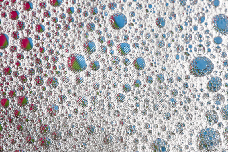 Close-ups of abstract soap bubbles and water droplets on multicolored background