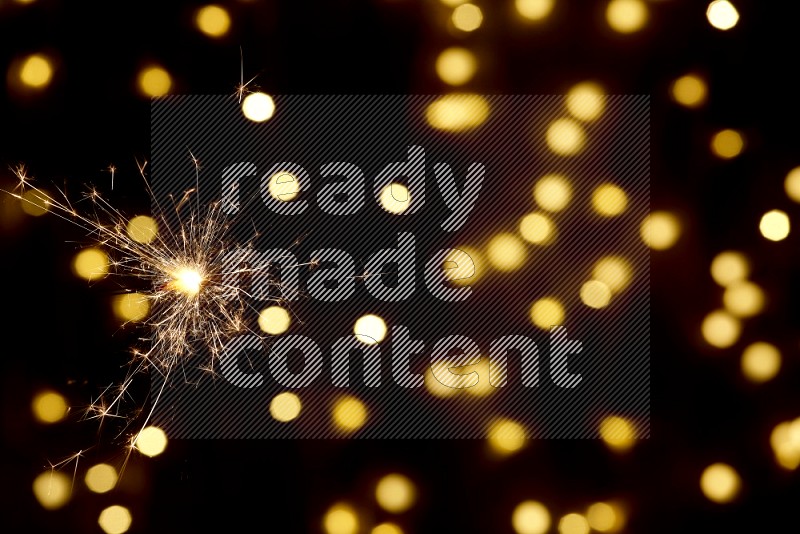 Sparkler candle with yellow light bokeh background