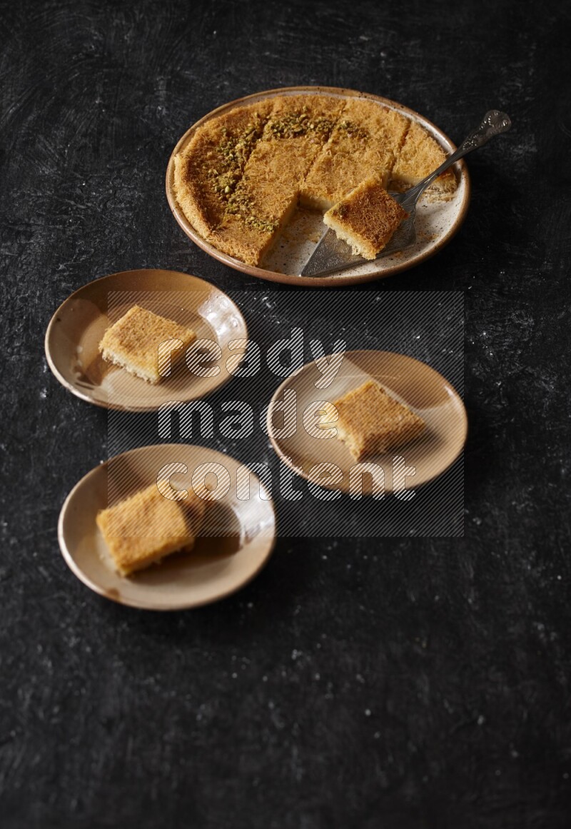 Konafa in different plates in a dark setup