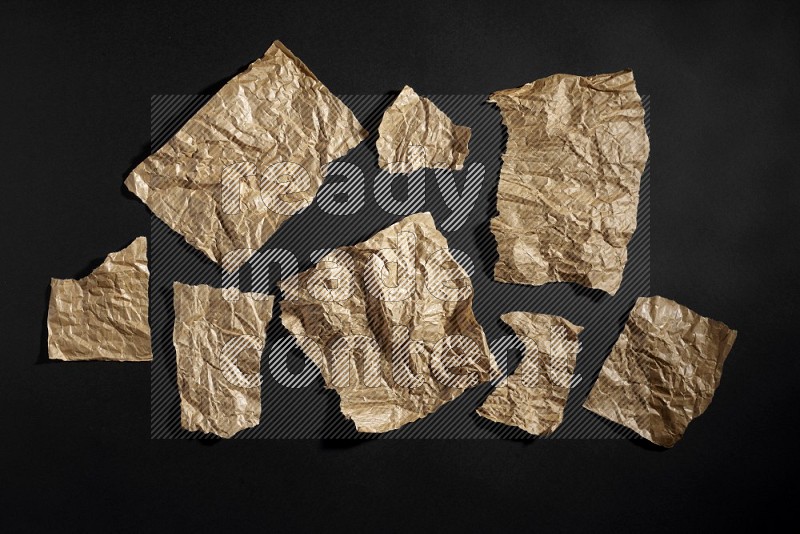 Crumpled craft paper on black background