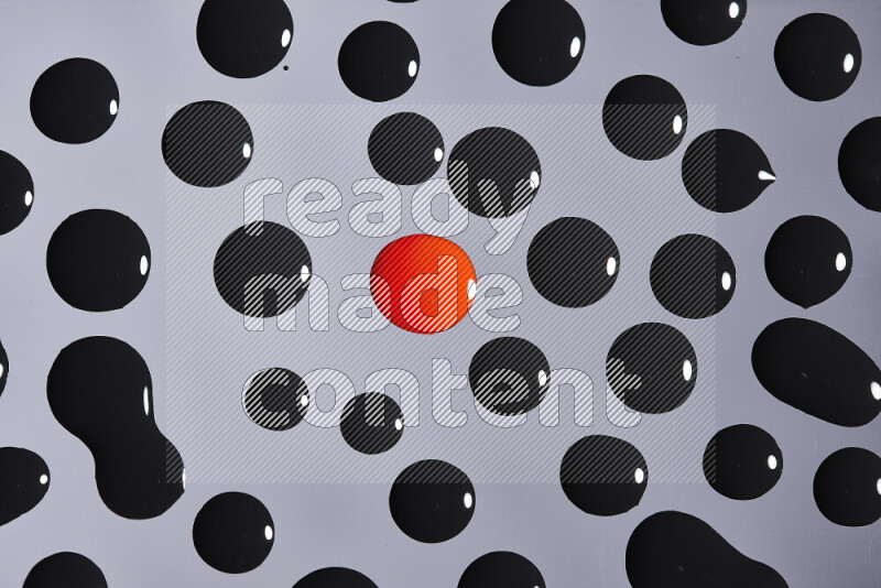 Close-ups of abstract red and black paint droplets on the surface