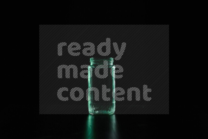 Glassware with rim light in green against black background