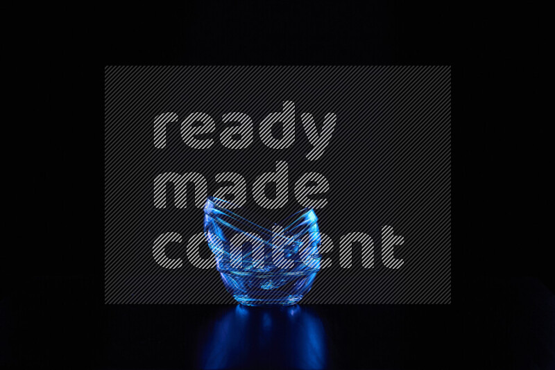 Glassware with rim light in blue against black background