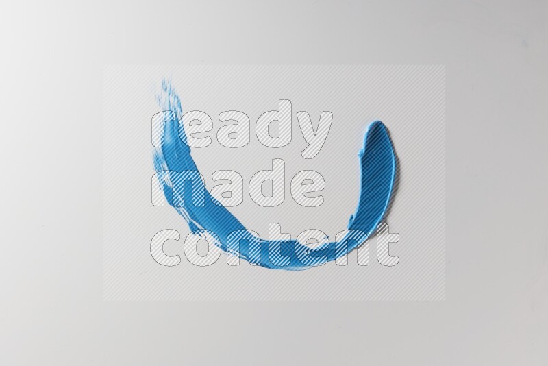 A blue single curved painting knife stroke on a white background