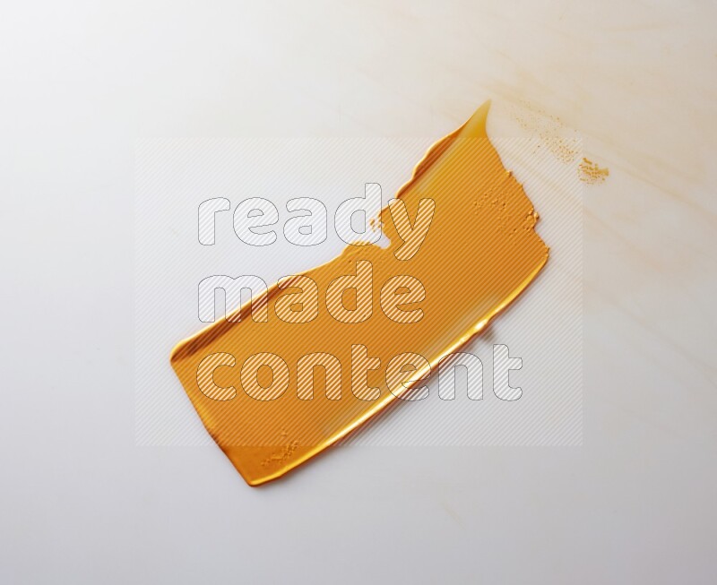 An orange straight painting knife stroke on white background