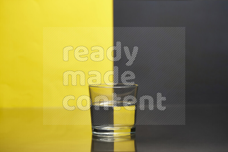 The image features a clear glassware filled with water, set against yellow and black background