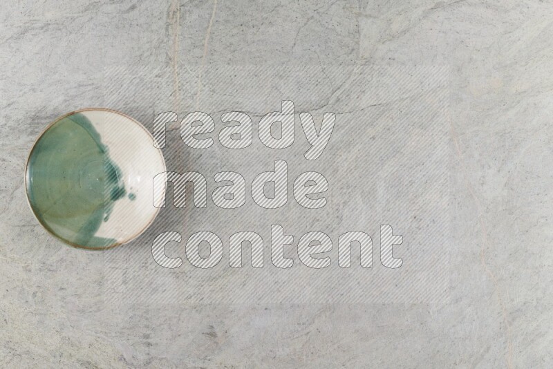 A multicolored pottery Bowl on grey marble background