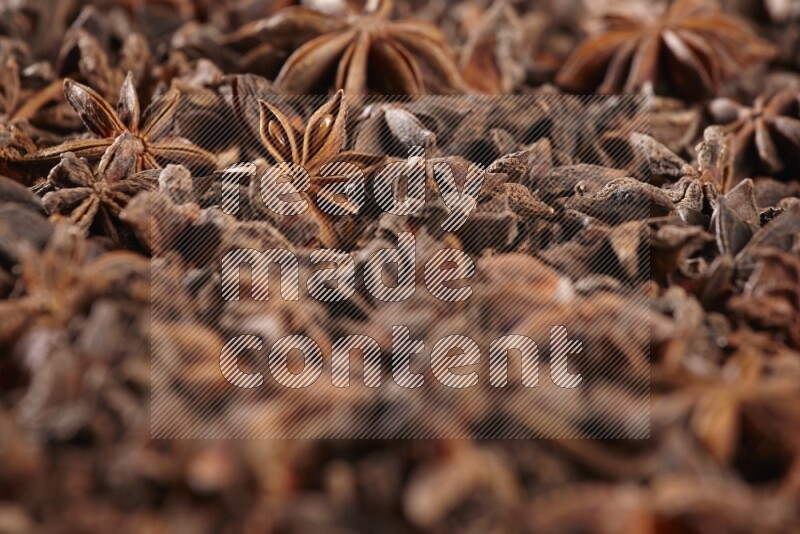 Star Anise herbs fill the frame on black flooring