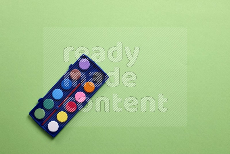 Watercolor paint set on green background (back to school)