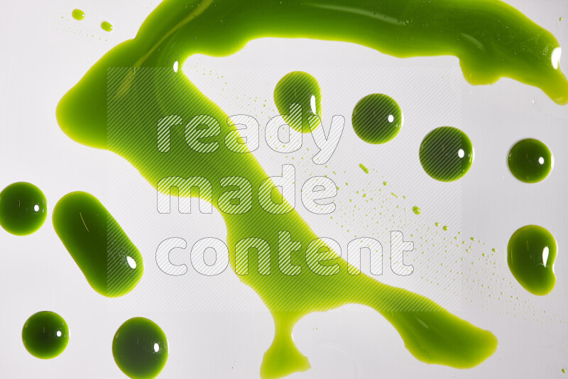 Close-ups of abstract green paint droplets on the surface