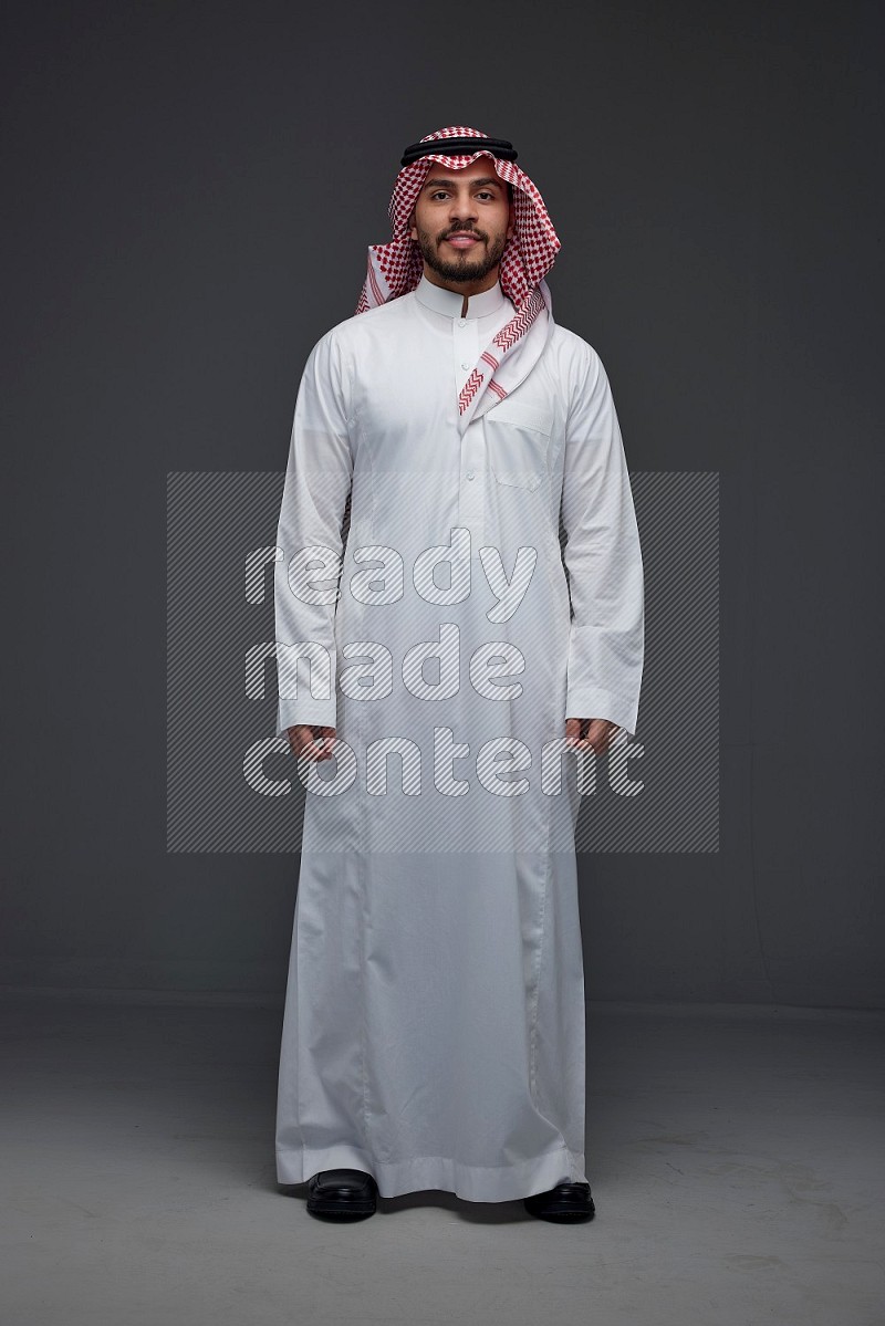 A Saudi man wearing Thobe and Shmagh standing in different poses eye level on a gray background