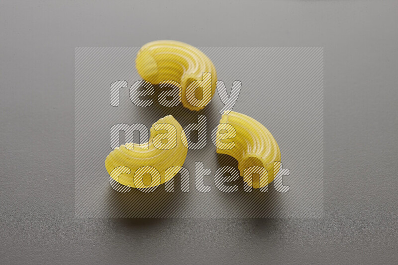 Elbow pasta on grey background