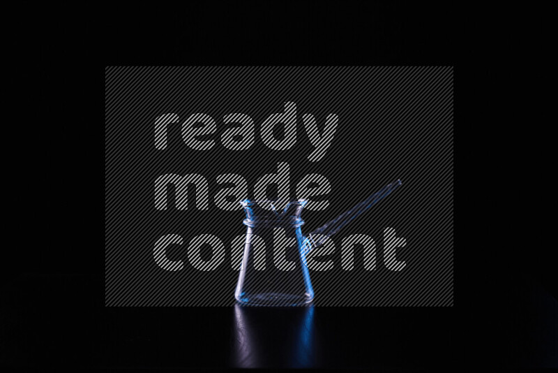 Glassware with rim light in blue and white against black background