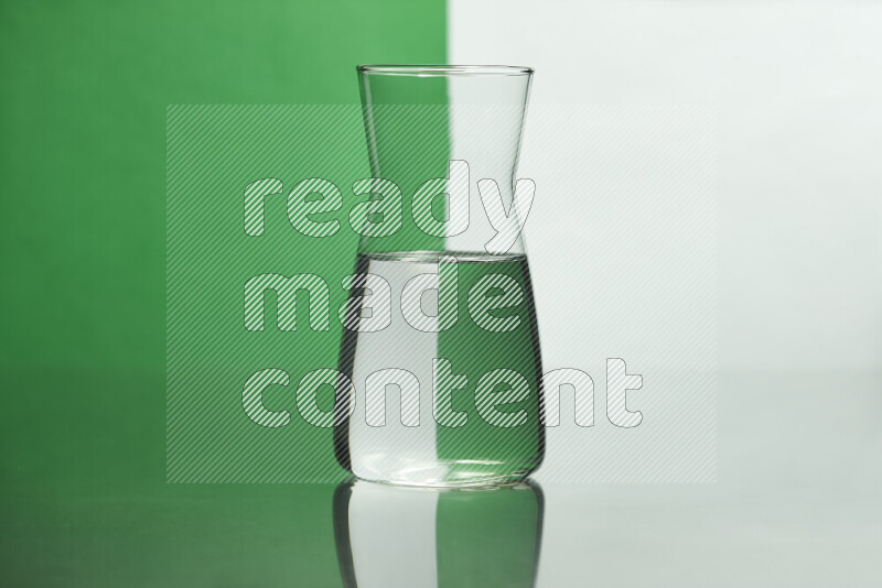 The image features a clear glassware filled with water, set against white and green background