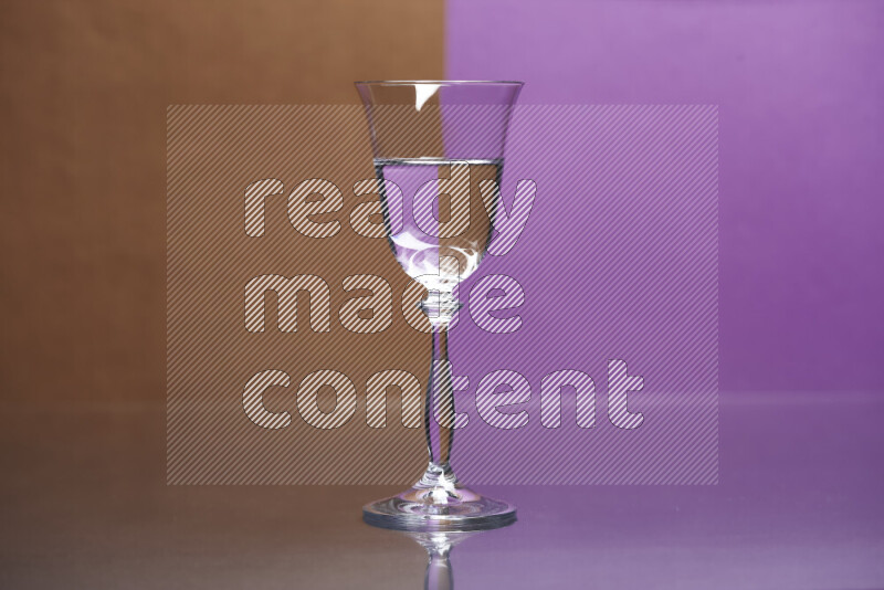 The image features a clear glassware filled with water, set against brown and purple background