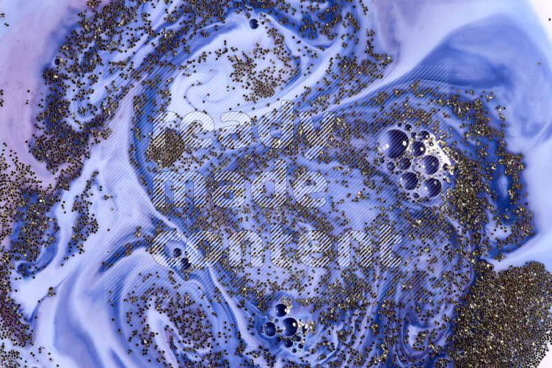 A close-up of sparkling gold glitter scattered on swirling blue and red background