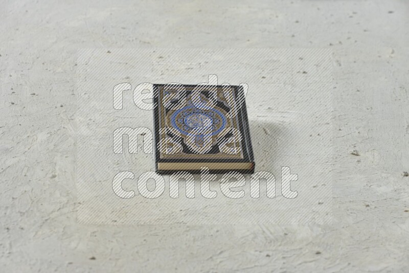 Quran with a prayer beads on white background