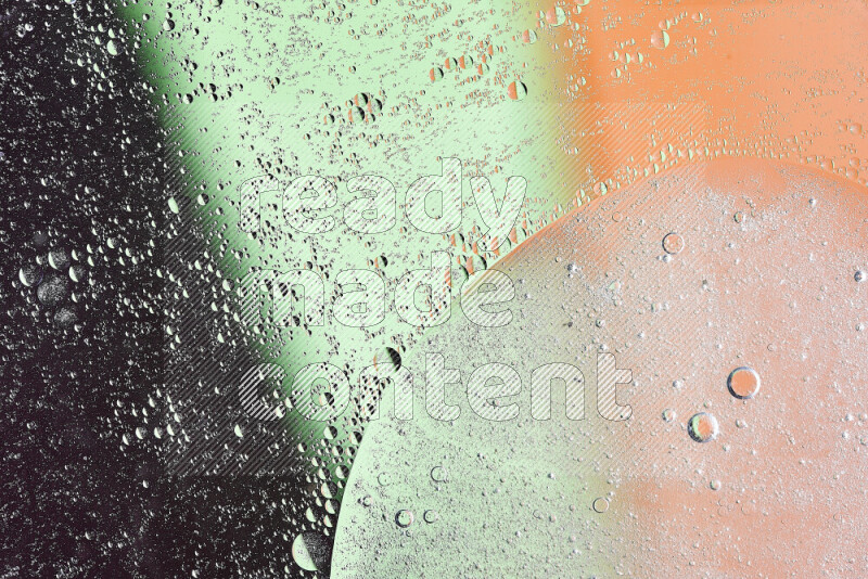 Close-ups of abstract oil bubbles on water surface in shades of green, orange and purple