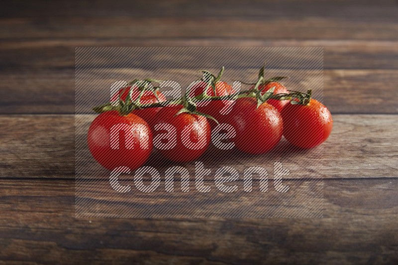 Red cherry tomato vein on a textured wooden background 45 degree