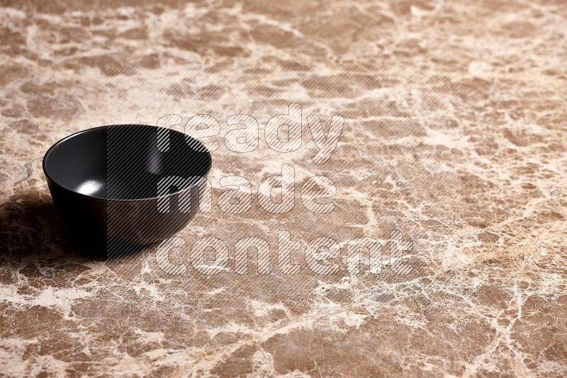 Black Ceramic Bowl on Beige Marble Flooring, 45 degrees