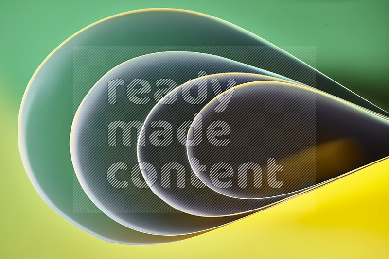 An abstract art of paper folded into smooth curves in green and yellow gradients