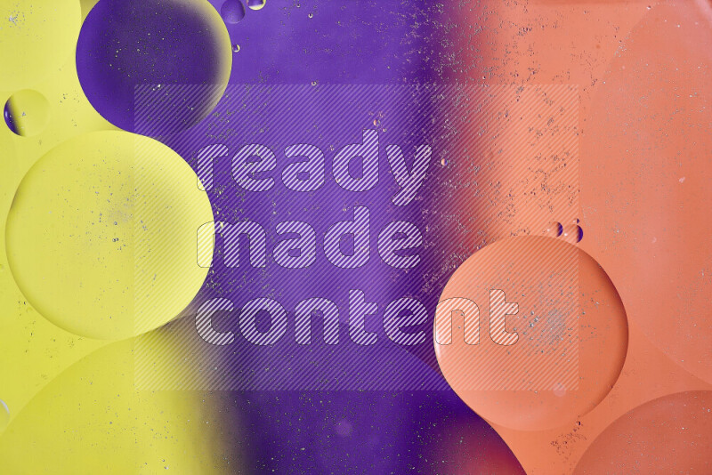 Close-ups of abstract oil bubbles on water surface in shades of yellow, orange and purple