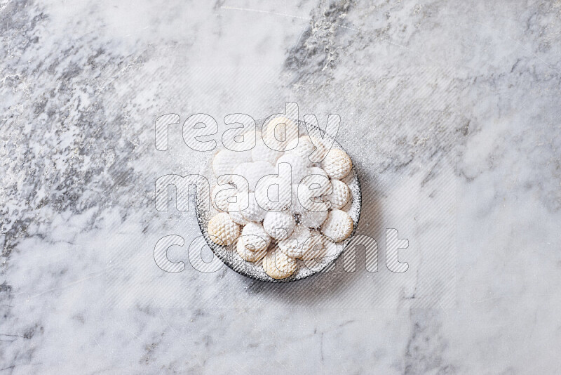 Kahk in black pottery plate on grey marble background