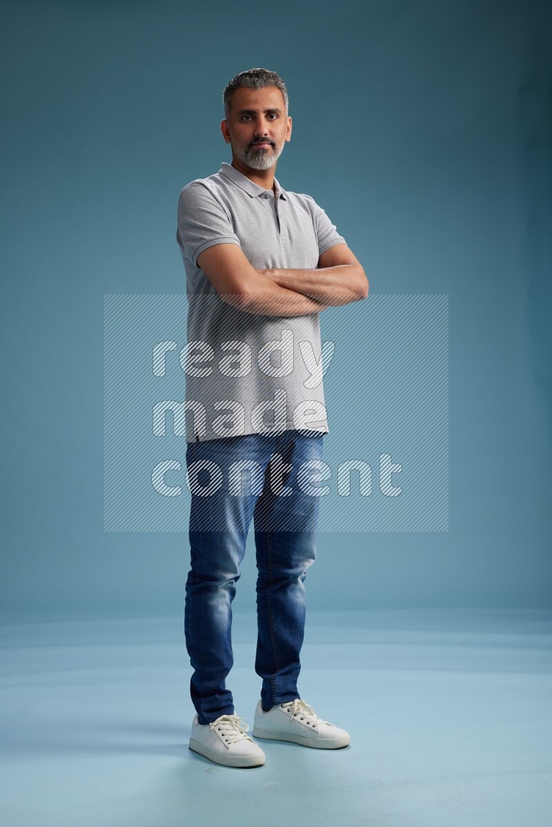Man Standing Interacting with the camera on blue background