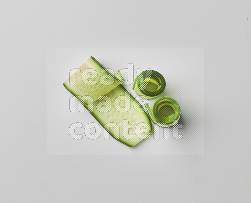 Three cucumber ribbons on a white background