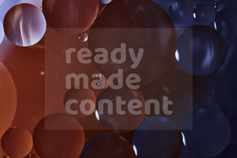 لقطات مقربة لفقاعات من الزيت على سطح الماء باللون الأسود والبرتقالي