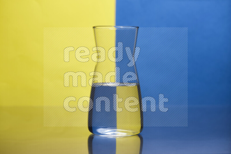 The image features a clear glassware filled with water, set against yellow and blue background