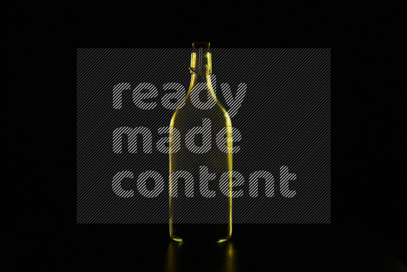 Water bottle with colored rim light against black background