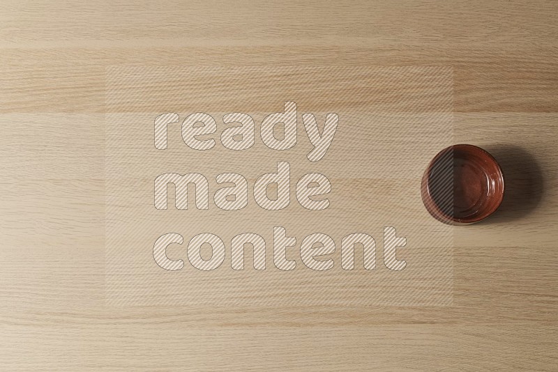 Top View Shot Of A Brown Pottery Bowl on Oak Wooden Flooring