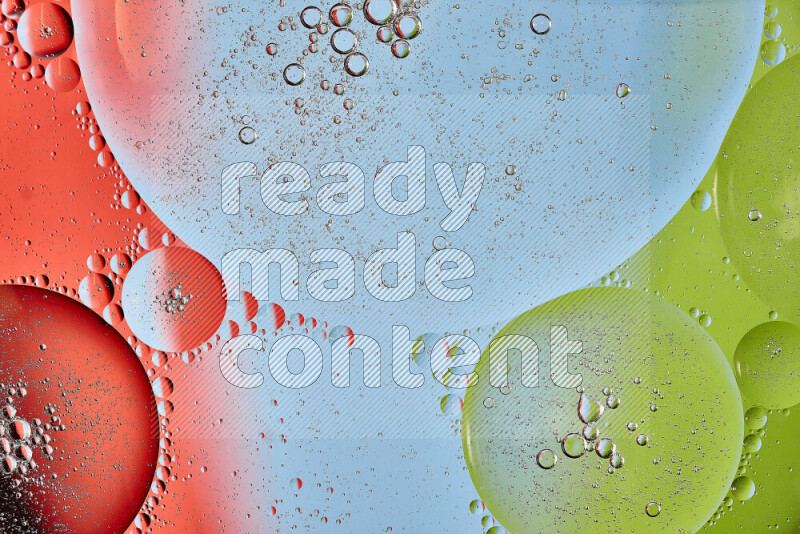 Close-ups of abstract oil bubbles on water surface in shades of red, green and blue