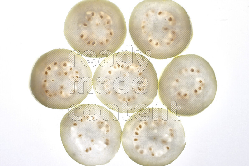 Guava slices on illuminated white background