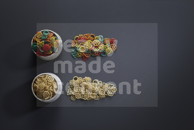 Legumes in pottery bowls on grey background