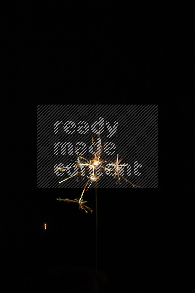 A close-up image of sparkler candle isolated on black background