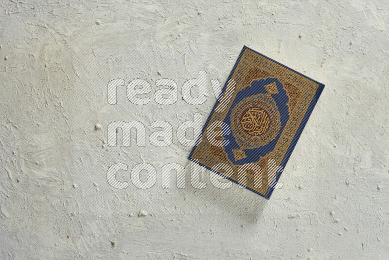 Quran with a prayer beads on white background