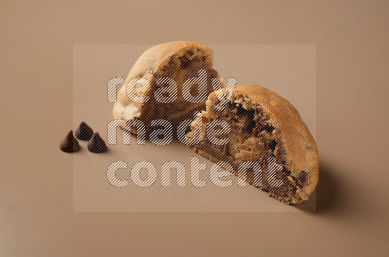 a cookie cut in half on a brown background
