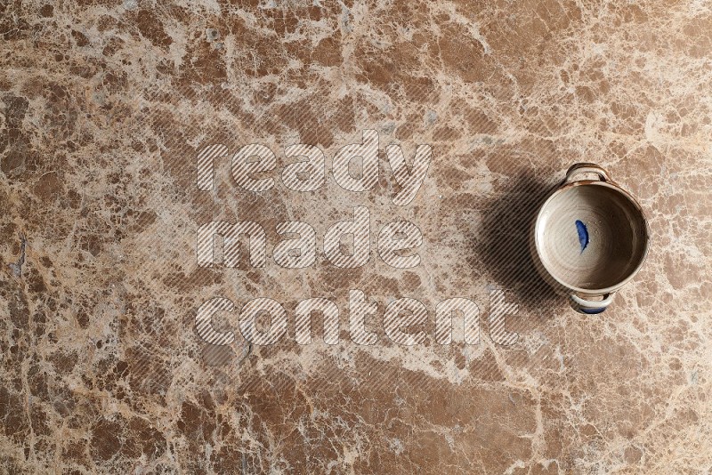 Top View Shot Of A Multicolored Pottery bowl On beige Marble Flooring